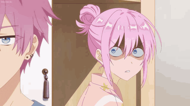 a girl with pink hair is making a funny face next to a boy