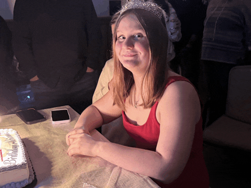 a woman wearing a tiara sits in front of a cake that says bridal