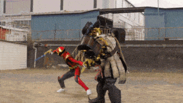 a man in a red suit is fighting a monster