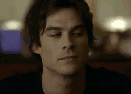 a close up of a man 's face with his eyes closed and a serious look on his face .