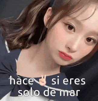 a close up of a girl 's face with the words " hace si eres solo de mar " written on the bottom