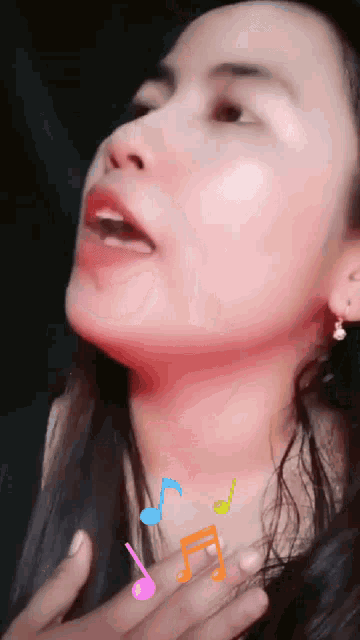 a close up of a woman 's face with colorful music notes around her