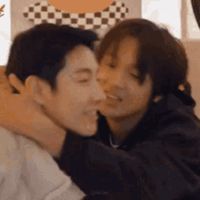 a man and a woman are hugging each other in a room .