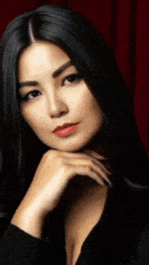 a close up of a woman 's face with her hand on her face