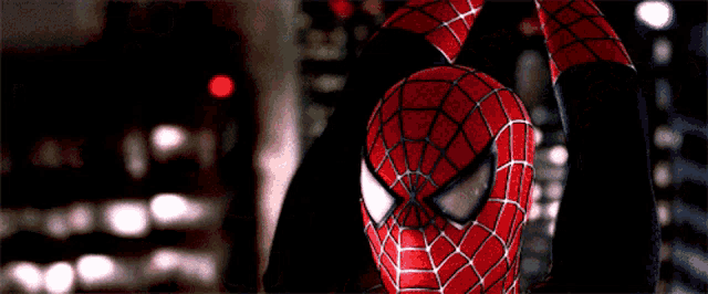 a close up of a spider man 's face with his arms outstretched