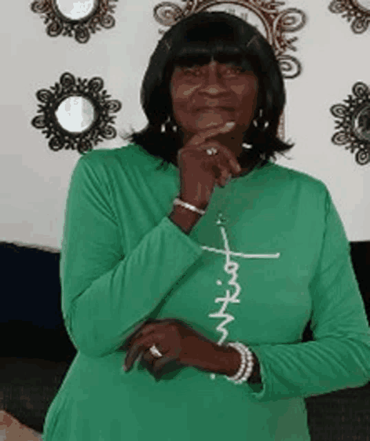 a woman in a green shirt with the word faith written on it