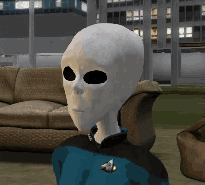 a gray alien with black eyes and a star trek badge