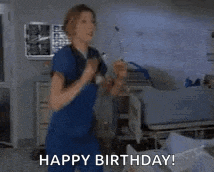 a nurse is dancing in a hospital room with the words `` happy birthday '' .
