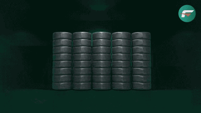 a person is holding a stack of tires with the letter f on the bottom right