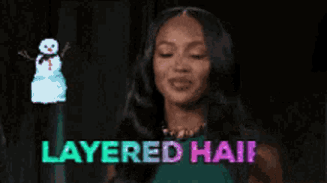 a woman in a green dress is standing in front of a snowman and says layered hair .