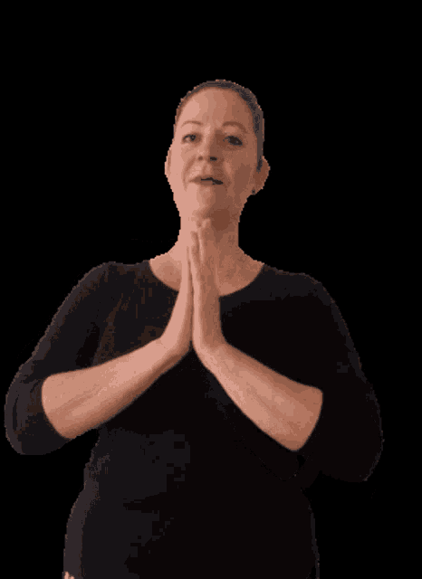 a woman with her hands folded in prayer