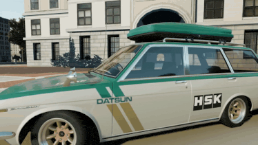 a datsun with a green roof box on top of it