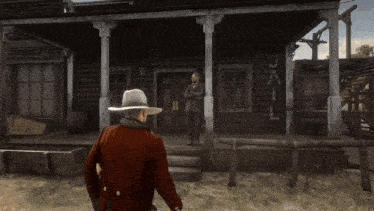 a man in a cowboy hat stands in front of a jail building