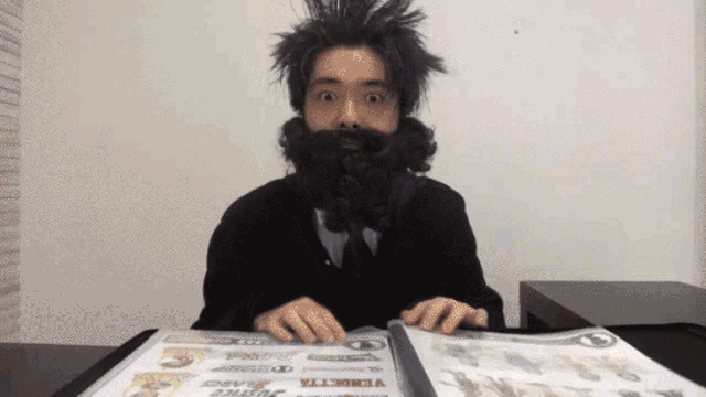 a man with a beard is sitting at a table with a menu that says vermette beard