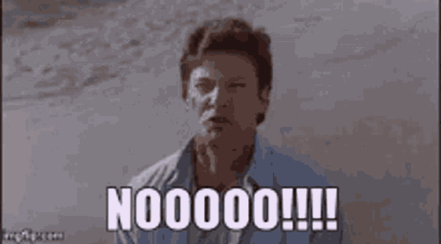 a man is screaming with his mouth wide open and the words nooooo !!! written on the screen .