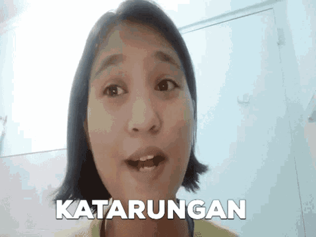 a close up of a woman 's face with the word katarungan written above her .