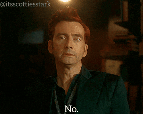 a man with red hair says no in front of a light