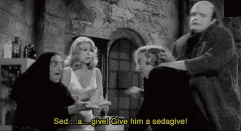 a group of people in a room with the words sed a give him a sedagive on the bottom