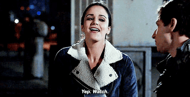a man and a woman are talking to each other and the woman is smiling .