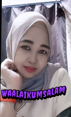 a woman wearing a hijab and a shirt that says waalaikumsalam on it