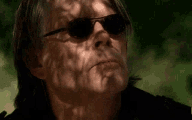a close up of a man 's face with a shadow on his face