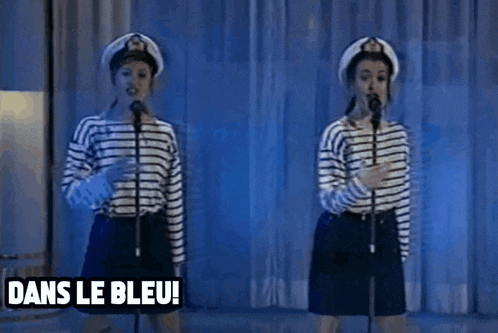 two women singing into microphones with the words dans le bleu ! dans le bleu written below them