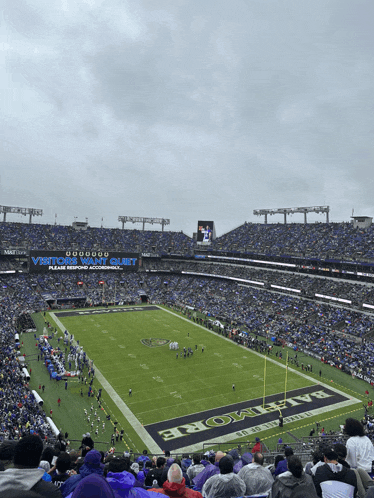 a football stadium with a banner that says visiting fans quiet