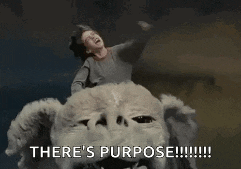 a boy is riding on the back of a monster with the words `` there 's purpose '' written on it .