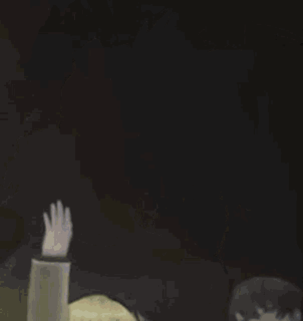 a group of anime characters are standing next to each other and waving their hands .