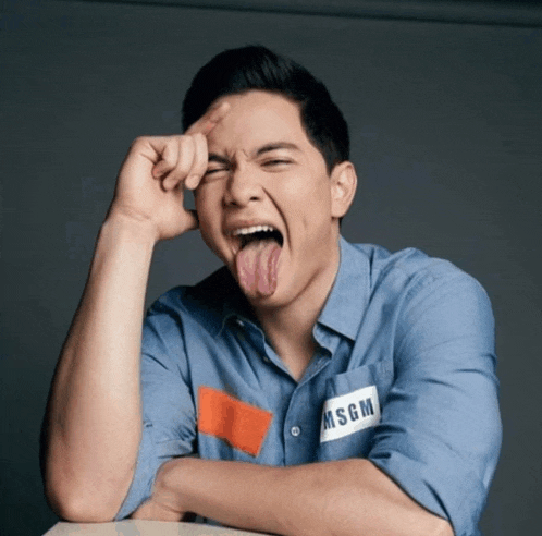 a man sticking his tongue out and wearing a shirt with msgm on it
