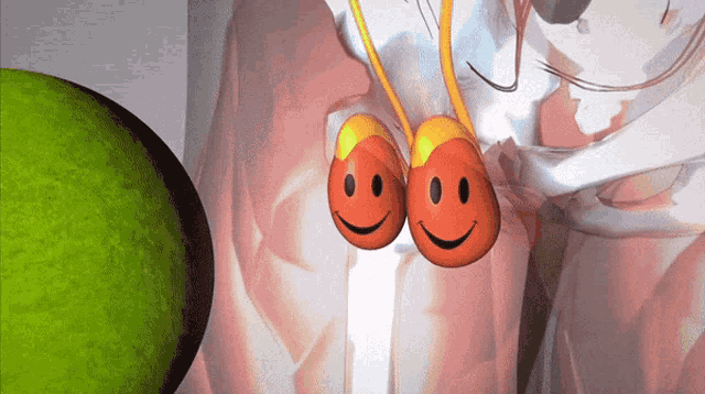 two smiley faces are hanging from a string on a white cloth