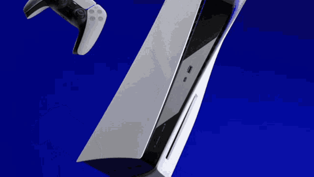 a playstation controller is floating in the air next to a playstation 5