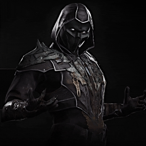 a man in a black hooded armor with a skull on his chest is giving a thumbs up