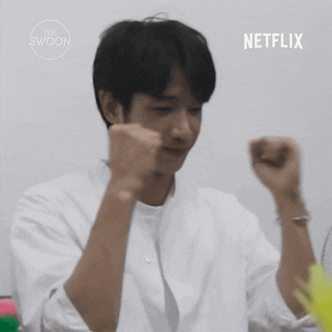 a man in a white shirt is making a fist with the netflix logo in the background .