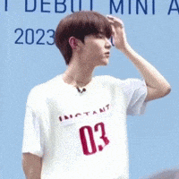 a young man in a white shirt with the number 03 on it
