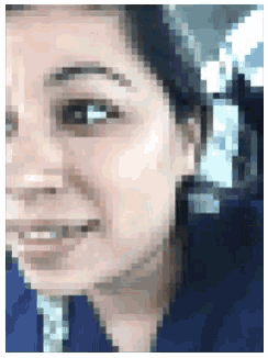 a pixelated image of a man 's face with a blue shirt on