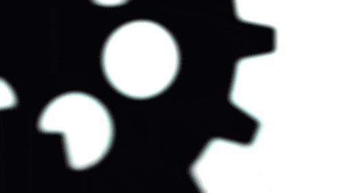 a silhouette of a person is behind a black gear
