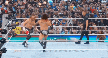 two wrestlers are in a ring with the word infinity on the floor .