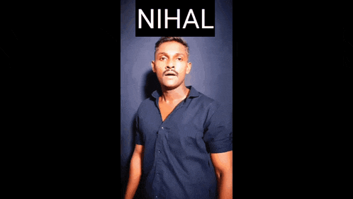 a man in a blue shirt is standing in front of a black background with the word nihal on it