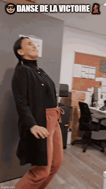 a woman is dancing in an office with the words danse de la victoire