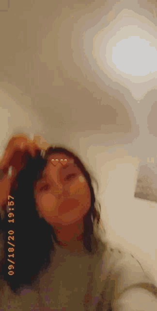 a girl is taking a selfie with a heart on her face and a heart on her nose .