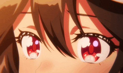 a close up of a girl 's eyes with red and white highlights