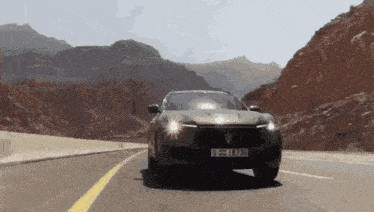 a car with a license plate that says u = l738 is driving down a road