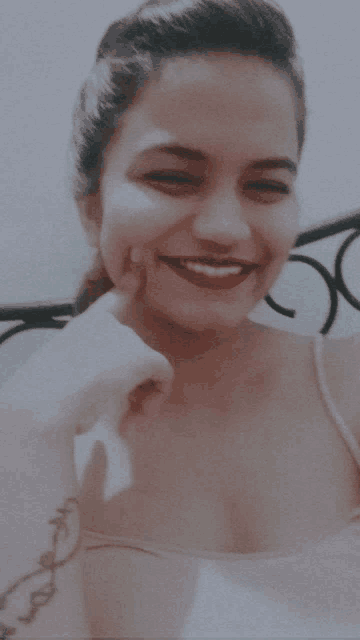 a woman with red lipstick is smiling and making a face