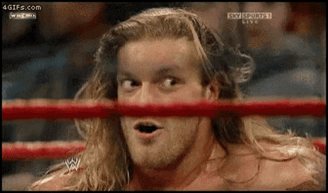 a man with long hair and a beard is in a wrestling ring with the words sky sports live on the bottom