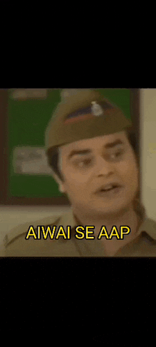 a man in a police uniform is sitting in a chair and making a funny face with his hand .