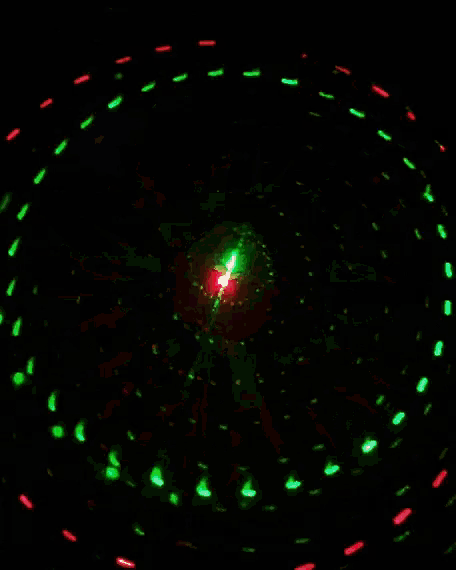 a red and green light with circles coming out of the center