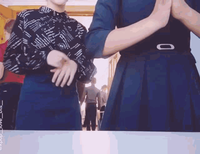 a woman in a black and white shirt is dancing