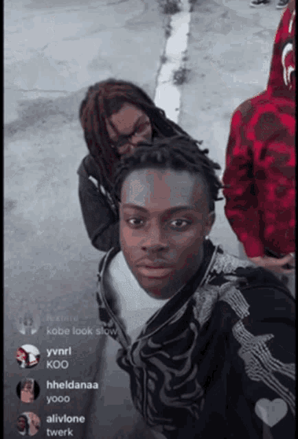a man with dreadlocks is standing next to another man