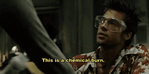 a man wearing goggles is holding a bottle and says " this is a chemical burn "